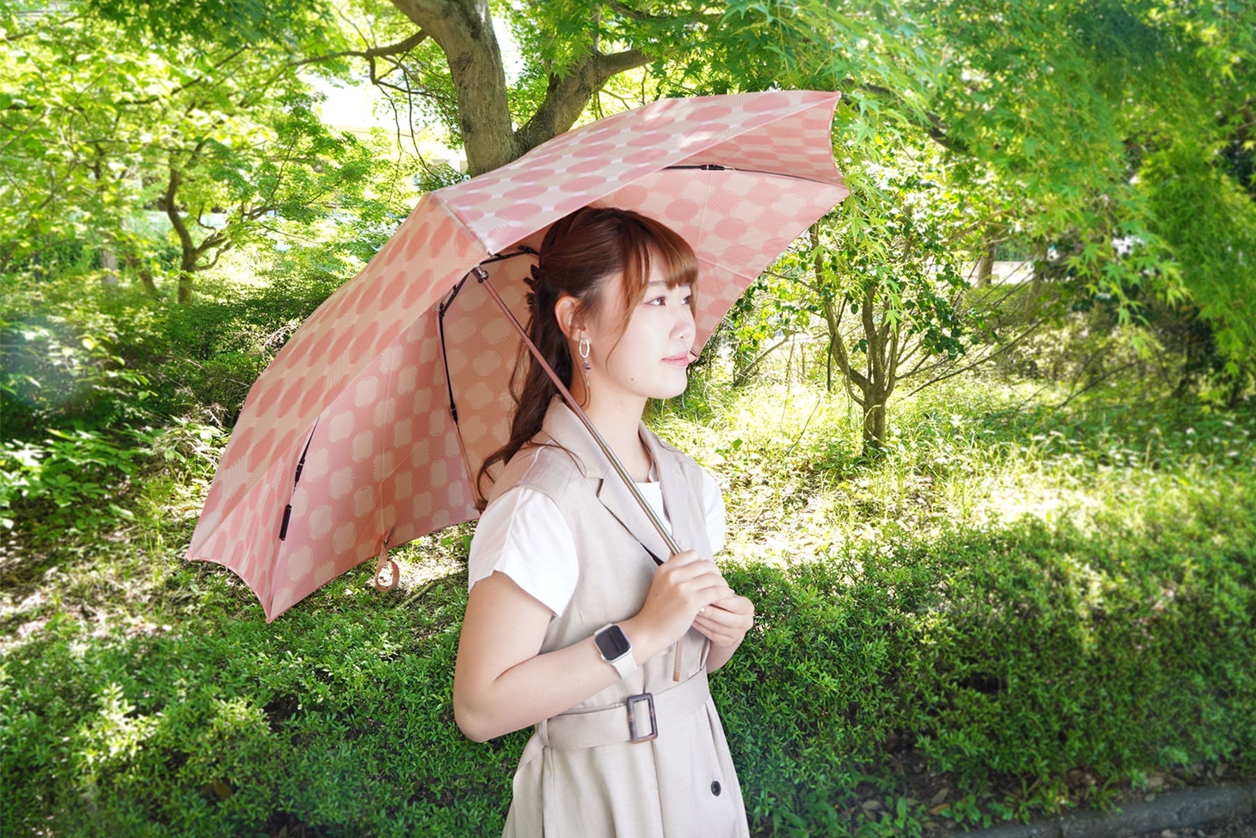 ピンク色の折りたたみ傘使用イメージ